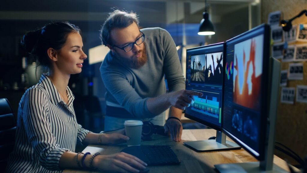 Digital Marketing Video Production two people one male and one female working on a computer editing a video | Navazon Digital