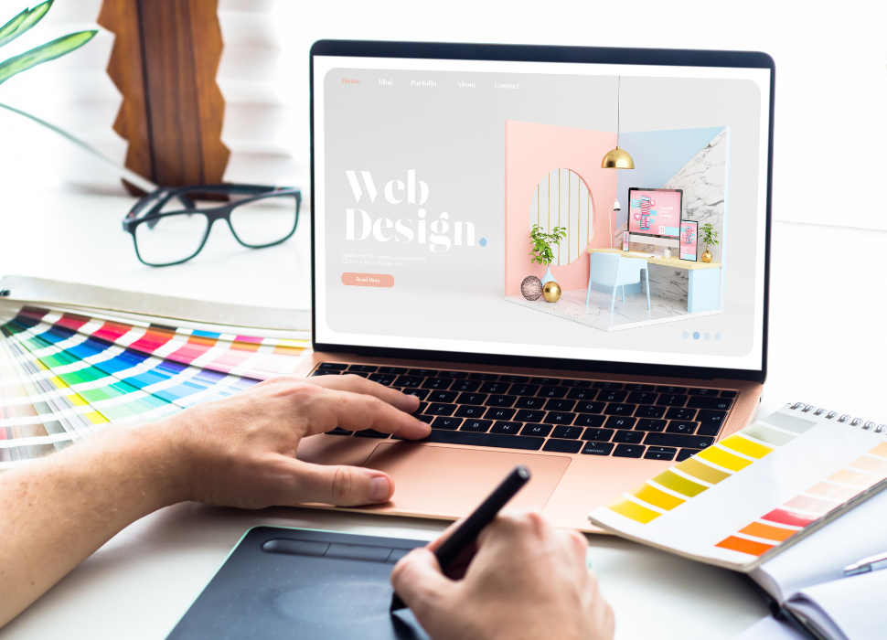 guide to web design / man drawing on desk with a computer open working on a website | Navazon Digital