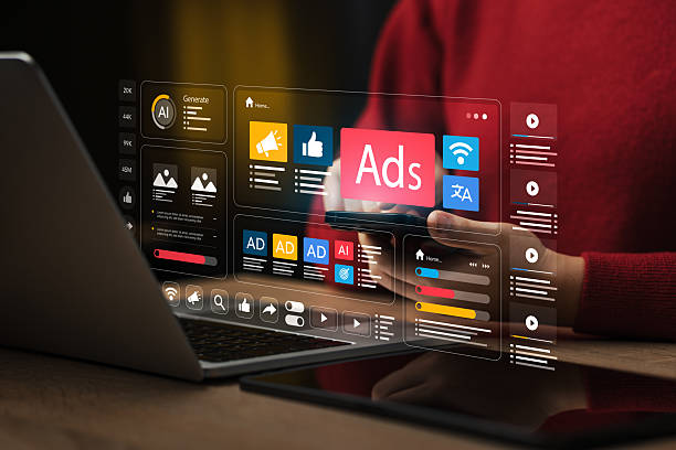 Person using a laptop with floating futuristic ads and analytics panels displayed above the keyboard.